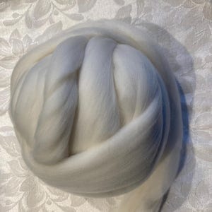 May include: A large ball of white wool yarn, perfect for knitting or crocheting.