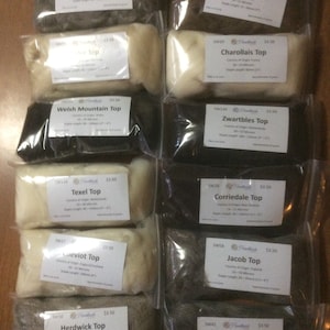 May include: Ten bags of wool top, each labeled with the breed of sheep, country of origin, micron count, staple length, and price. The wool tops are in various colors, including white, gray, and black.