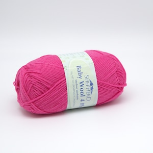 May include: A pink ball of SHEPHERD Baby Wool 4 Ply yarn. The label reads "Machine Washable 50g NET WT STANDARD CONDITIONS".