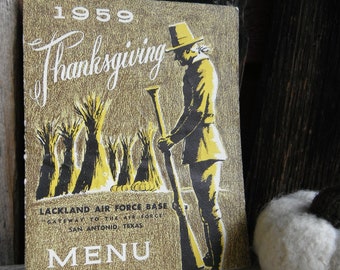 May include: Vintage Thanksgiving menu from 1959. The cover features a gold and black illustration of a pilgrim with a rifle, wheat stalks, and the text "Thanksgiving." The menu is from Lackland Air Force Base in San Antonio, Texas.