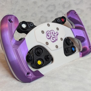 May include: A racing wheel with a white center and purple accents. The wheel has multiple buttons and a logo that says "3D GT". The wheel is designed for gaming.
