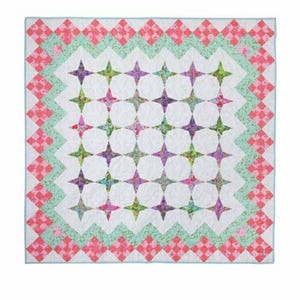 May include: A square quilt with a white background and a star pattern. The stars are in shades of purple, green, and pink. The quilt has a border of pink and green diamond shapes. The quilt is approximately 60 inches square.