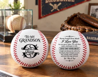 May include: Two white baseballs with red stitching featuring black printed text. One baseball displays the text TO MY GRANDSON, a large letter O, and the name Oliver. The other baseball features the text Never Forget How Much I Love You.