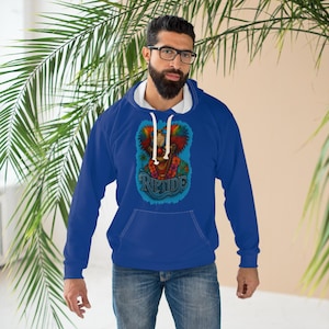 May include: A royal blue hoodie with a white-lined hood. The front features a colourful clown graphic with the word "RIPTIDE" in a wave-like design. The hoodie has a kangaroo pocket and white drawstrings.