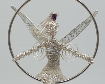 Small handmade wire fairy sitting in a hoop, window hanger. wire sculpture ornament
