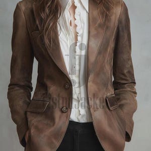 May include: A brown leather blazer with a classic two-button closure and notched lapels. The blazer features two front pockets and a tailored fit. The model is wearing a white collared shirt underneath. The blazer is a medium brown color.