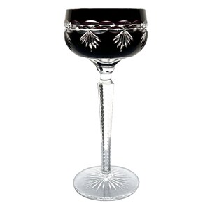 May include: A tall, clear glass with a black, faceted bowl and a cut stem. The base of the glass is also cut.