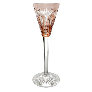May include: A tall, elegant crystal wine glass with a pink-tinted bowl and a clear, slender stem. The bowl features intricate cut patterns, and the base is a clear, circular design. The glass is designed for serving wine.