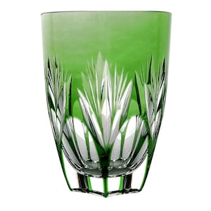 May include: A green glass tumbler with a cut crystal design. The glass has a rounded bottom and a flared top.