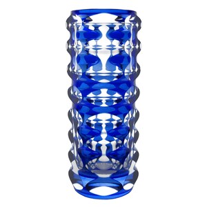 May include: A tall, cylindrical vase with a striking blue and clear geometric design. The vase features a repeating pattern of rounded shapes, creating a textured, eye-catching surface. The vase is made of glass and is suitable for home decor.