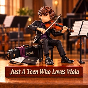 May include: A figurine of a musician with brown hair playing a wooden viola while seated on a bench. The base is engraved with the text "Just A Teen Who Loves Viola." A black instrument case and a music folder, both labelled "Noah," sit nearby.