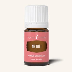May include: A small glass bottle of Neroli premium essential oil. The bottle has a white cap and a pink label with the words "NEROLI" in a brown rectangle. The label also includes the text "YOUNG LIVING" and "0.17 fl. oz. (5 ml)".