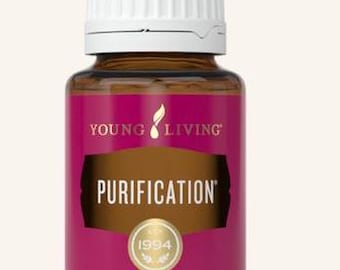 May include: A brown glass bottle of Young Living Purification essential oil blend. The bottle has a white cap and a label with the words "PURIFICATION" and "1994". The label is a deep pink colour with gold accents. The bottle contains 15 ml.