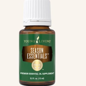 May include: A brown glass bottle of Young Living Season Essentials premium essential oil supplement. The bottle has a white cap and a green label with the words "SEASON ESSENTIALS" and "0.5 fl. oz. (15 ml)".