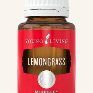 May include: A brown glass bottle of Young Living Lemongrass essential oil. The bottle has a white cap and a red label with the words "LEMONGRASS" and "SEED TO SEAL PREMIUM ESSENTIAL OIL". The bottle contains 0.5 fl. oz. (15 ml).