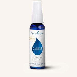 May include: A blue glass spray bottle with a white top. The bottle has a label with the text "CLARADERM COOLING MIST". The bottle contains 2 fl oz (59 ml) of product and is from Young Living.