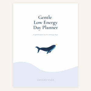 May include: A white planner titled "Gentle Low Energy Day Planner" with a blue whale illustration and a gold star. The text "A gentle plan for low energy days" is below the title. The bottom of the planner reads "GENTLE DRIFT STUDIO."