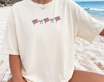 アメリカ国旗リボンシャツ かわいい愛国的なTシャツ 7月4日シャツ USA かわいいリボンシャツ シンプルな赤白青シャツ コケットUSAアウトフィット