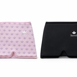 May include: Two eye masks, one pink and one black, are displayed on a white background. The pink mask has a repeating floral pattern and the word "Serein". The black mask has the word "Serein" and a floral logo.