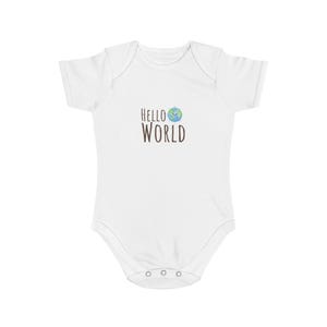May include: White baby bodysuit with short sleeves. The bodysuit features the text "HELLO WORLD" in brown letters, with a smiling globe graphic. The bodysuit has three poppers at the bottom.