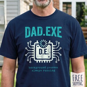 May include: Navy blue t-shirt with the text "DAD.EXE" in teal above a white and teal circuit board graphic. Below the graphic, the text reads "background process always running".