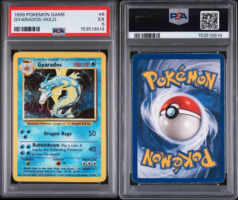 May include: A graded 1999 Pok&eacute;mon Game Gyarados-Holo card. The front of the card features a blue and yellow design with a Gyarados illustration and text. The back has a blue background with the Pok&eacute;mon logo and a Pok&eacute; Ball.