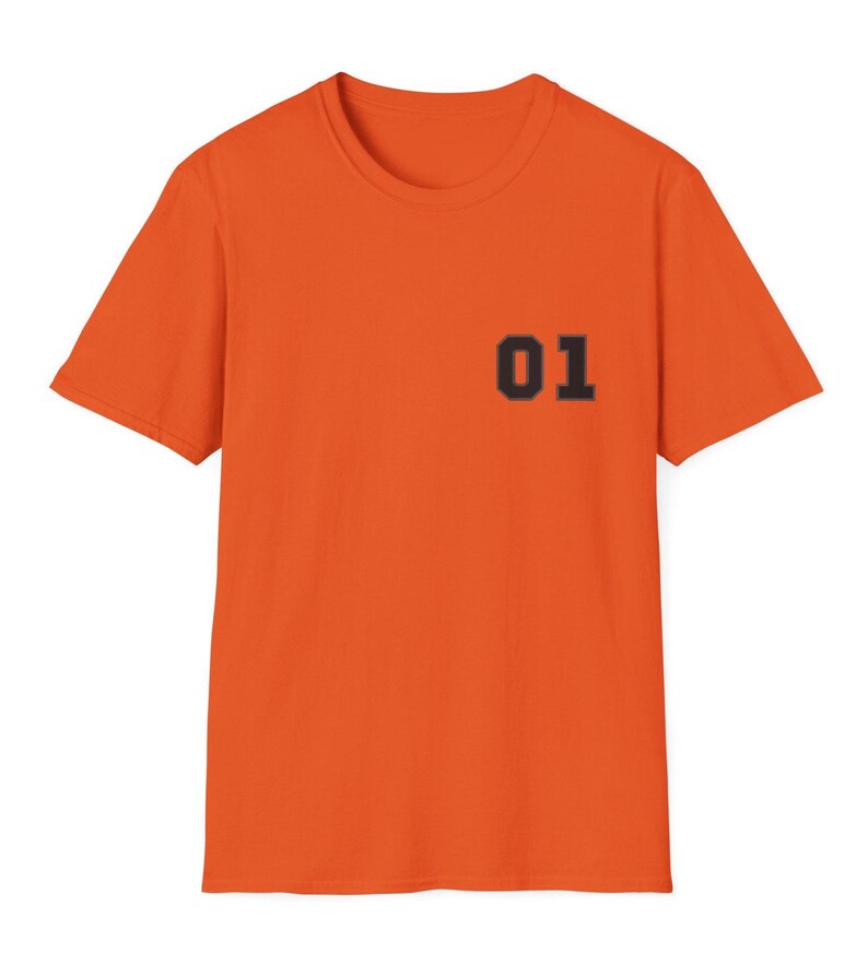 May include: A bright orange short-sleeved t-shirt featuring a crew neckline. The front of the garment displays the number 01 printed in a bold, dark, block-style font on the upper left chest area, providing a clear contrast to the fabric.