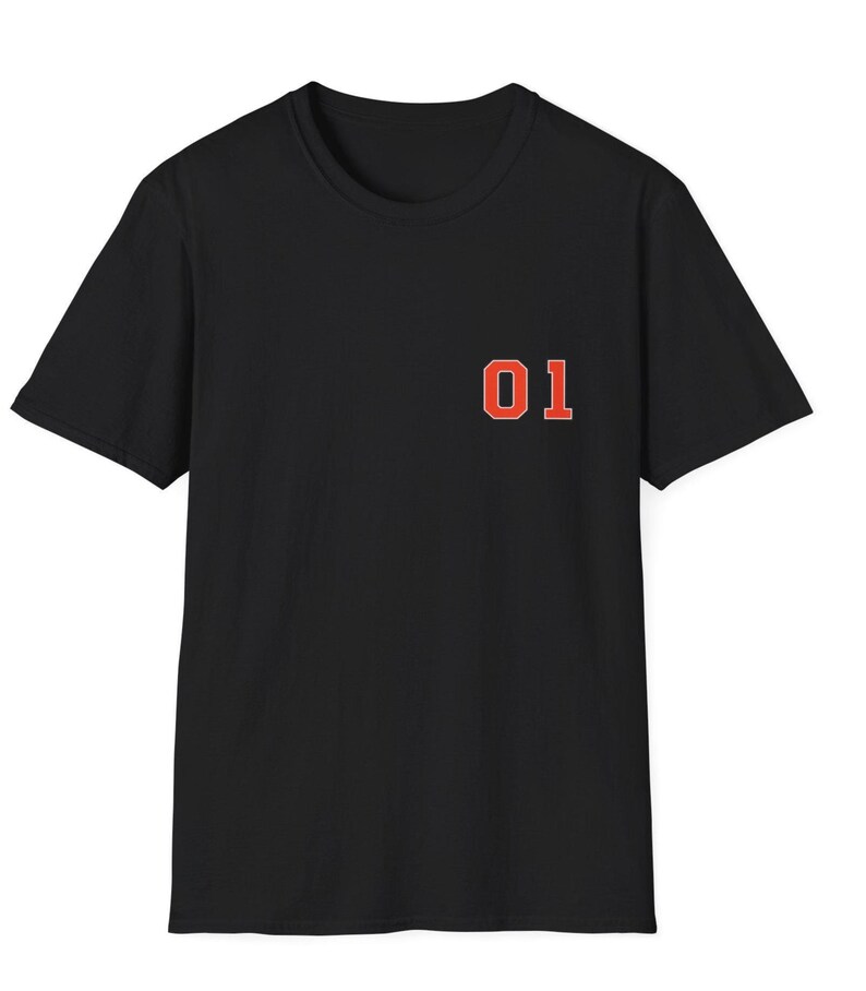 May include: A black short-sleeved t-shirt featuring the number 01 printed on the left chest in a bold orange font with a thin white outline. The garment has a classic crew neckline and a straight hem, providing a simple and clean design.