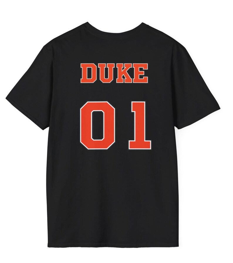 May include: A black short-sleeve t-shirt featuring the word DUKE in orange block letters above the large orange number 01, both outlined in white, centered on the back of the garment.