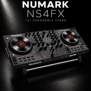 May include: Black Numark NS4FX DJ controller with two circular jog wheels, numerous buttons, and sliders. The text "NUMARK NS4FX 15° ERGONOMIC STAND" is displayed at the top. The Serato logo is visible. The bottom of the image displays the text "fatlikejabba".