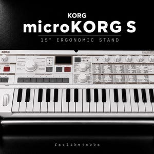 May include: A white Korg microKORG S synthesiser with wood-tone side panels, black and white keys, and numerous control knobs and buttons. The keyboard is mounted on a silver and black 15-degree ergonomic stand. Text on the unit includes KORG, microKORG S, and 15 DEGREE ERGONOMIC STAND.