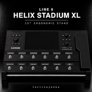 May include: A black Line 6 Helix Stadium XL guitar processor unit featuring a 15-degree ergonomic stand. The device includes a central screen, multiple metallic footswitches, control knobs, and an integrated expression pedal on the right side.