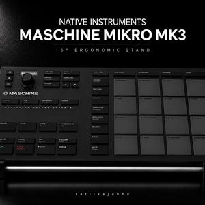 May include: A black Native Instruments Maschine Mikro MK3 music production controller resting on a 15-degree ergonomic stand. The device features a grid of sixteen square pads, a rotary encoder, and various labeled buttons for sequencing and sampling.