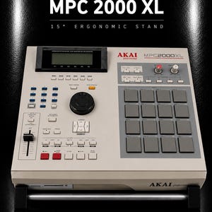 May include: An Akai MPC 2000 XL drum sampler and sequencer resting on a 15-degree ergonomic stand. The device features a light grey chassis, a black display screen, a large black data wheel, sixteen grey drum pads, and various control buttons.