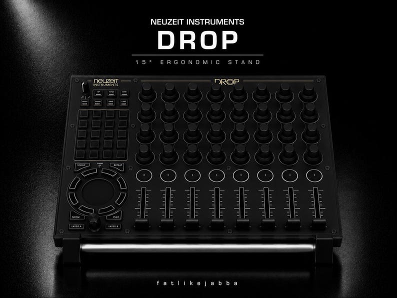 Puede incluir: Un soporte ergon&oacute;mico negro Neuzeit Instruments Drop de 15 grados con una rejilla de perillas, un panel t&aacute;ctil circular, m&uacute;ltiples faders y una matriz de botones. El dispositivo tiene las etiquetas Neuzeit Instruments, Drop y fatlikejabba.