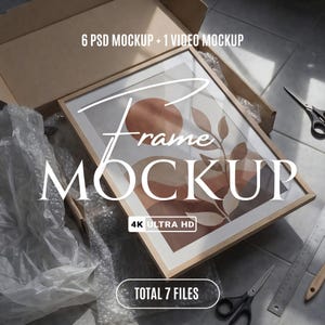 May include: A framed art print mockup with a light wood frame, inside a cardboard box. The art print features a minimalist design with earth-tone shapes. Text on the image reads "Frame MOCKUP", "4K ULTRA HD", and "TOTAL 7 FILES".