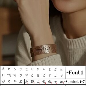 May include: A copper cuff bracelet with the word "prefect" stamped on it. The image also shows two font styles and symbols for personalization. The text "Personalized Text" is at the top of the image.