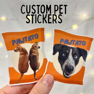 May include: Custom pet stickers featuring dogs in a chip bag design. The stickers are orange and white with the text "PAWTATO" and the words "CUSTOM PET STICKERS" in black. The sticker height is 2.5 inches.