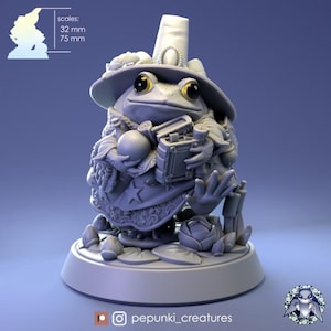 May include: A detailed, grey 3D-printed figurine of a frog wizard. The frog wears a tall hat, a robe with star details, and holds a book and a crystal ball. The base includes lily pads and a rose. Scales: 32 mm and 75 mm.
