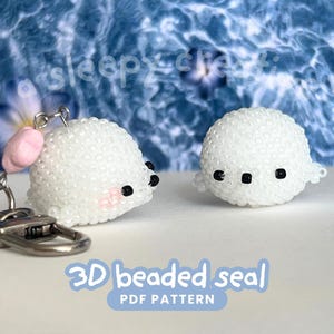 May include: Two white beaded seal figures. One is attached to a keychain with a silver clasp and a pink ear. The other seal is a standalone figure. Both seals have black eyes and are on a light blue background. Text on the image reads "3D beaded seal PDF pattern."