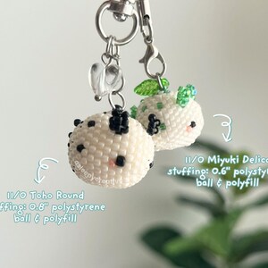 May include: Two round beaded charms with silver lobster clasps. One features 11/0 Toho Round beads with a 0.8-inch polystyrene ball and polyfill. The other uses 11/0 Miyuki Delica beads with a 0.6-inch polystyrene ball and polyfill. Both have small heart charms.