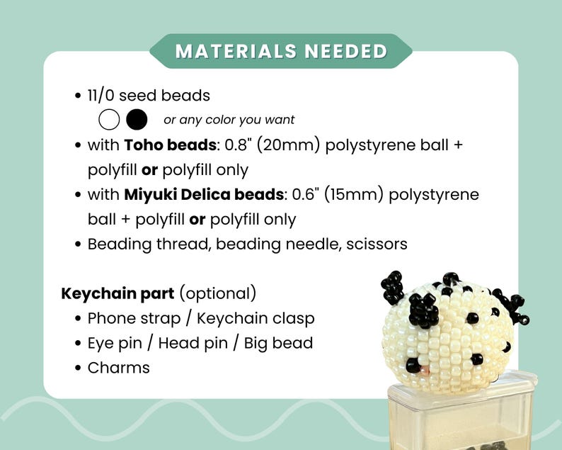 May include: A craft instruction card titled MATERIALS NEEDED listing 11/0 seed beads, 0.8 inch and 0.6 inch polystyrene balls, polyfill, thread, needle, and scissors. A small, round, white beaded sphere with black accents sits in the corner.