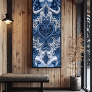 May include: A framed, abstract artwork with a symmetrical design in shades of blue and white. The artwork is displayed on a wooden wall, with a bench and a small tree in the foreground. The room has a rustic, cabin-like aesthetic.