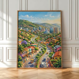 May include: A framed wall art print depicting a vibrant cityscape of Kigali, Rwanda. The illustration features a winding road through a hilly urban landscape with colorful buildings, lush green trees, palm plants, and vehicles under a blue sky.