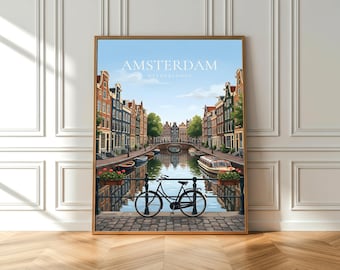 May include: Framed art print of Amsterdam, Netherlands. The artwork depicts a canal scene with colorful buildings, a bridge, boats, and a bicycle. The sky is blue with a few clouds. The print is in a gold frame.