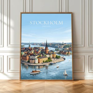 May include: A framed art print depicting Stockholm, Sweden. The image shows a detailed illustration of the city's waterfront, with boats, buildings, and a clear blue sky. The word "STOCKHOLM" is printed at the top of the image.