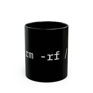 May include: A black coffee mug with white text that reads "rm -rf /". The mug is cylindrical and has a glossy finish. The text is in a sans-serif font and is centered on the mug.
