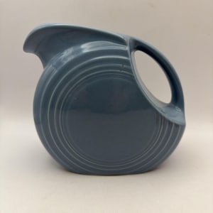 May include: A set of three ceramic mugs with a speckled, matte finish. The mugs are in shades of cream, light gray, and dark gray. Each mug has a simple, minimalist design, perfect for coffee or tea.