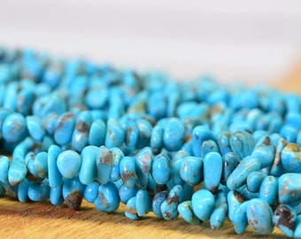 May include: A strand of turquoise chip beads, featuring a mix of light and dark blue hues with brown veining. The beads are irregularly shaped and have a smooth, polished finish.