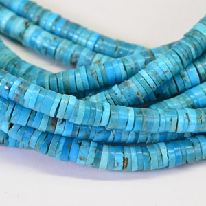 May include: A strand of turquoise beads, each bead is a flat, round disc with a light blue color. The beads are stacked on top of each other, creating a layered effect.